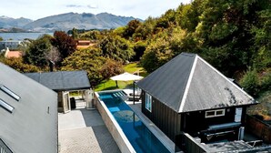 A modern house with a swimming pool, a covered patio, and a view of mountains. - Mishika Retreat and Lodge (Wānaka)