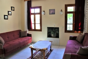 Una sala de estar con dos sofás, una mesa y una chimenea.