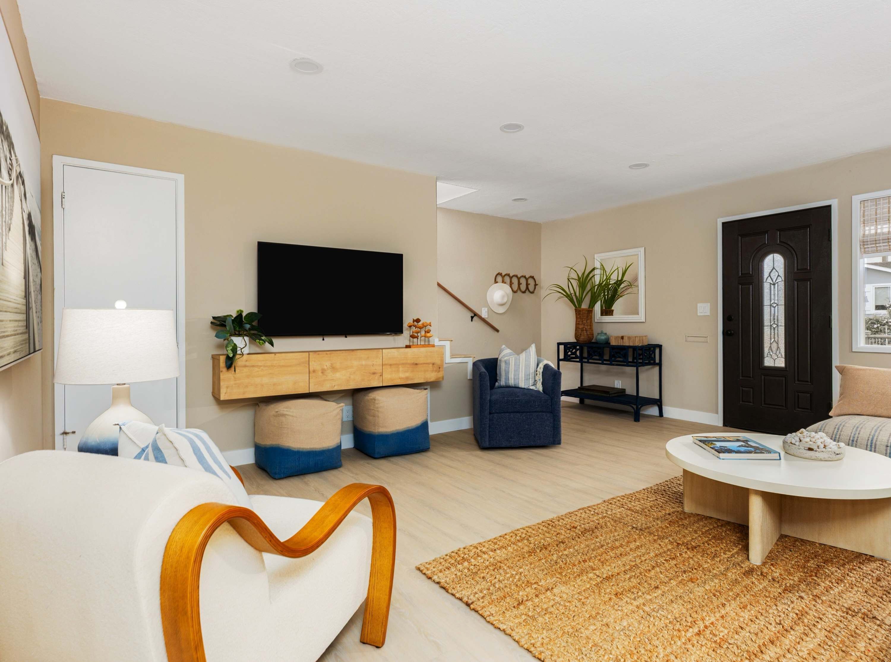 A living room with a sofa, a coffee table, a TV, and a bookshelf.