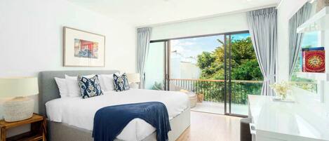 A modern bedroom with a large bed, a bedside table, a nightstand, a ceiling fan, a window with curtains, and a balcony with a view of greenery.