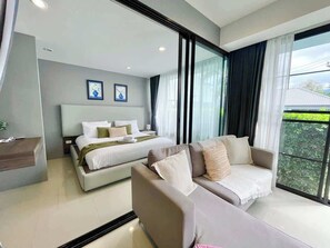 A modern hotel room with a large bed, a sofa, and a desk. - Villa 1 - Holiday Villa with Pool, 1 minute from Fisherman's Village (Ko Samui District)