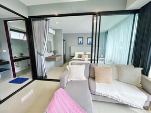 A modern hotel room with a sofa, a bed, a bathroom, and a dining area. - Villa 1 - Holiday Villa with Pool, 1 minute from Fisherman's Village (Ko Samui District)