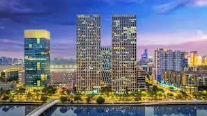 A cityscape with modern high-rise buildings, a river, and a bridge. - Wanhao Max Hotel - Guangzhou Pazhou (Guangzhou)