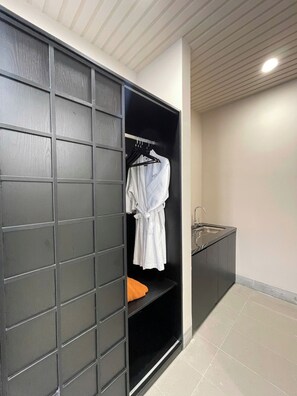 A modern bathroom with a built-in shower, a towel rack, and a sink. - Min Min Retreat Homestay (Hue)