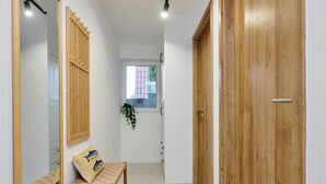 A hallway with a wooden bench, a large mirror, and a wooden door. - Perfect 2-bedroom lodge with AC in peaceful Balatonmáriafürdő (Balatonmáriafürdő)