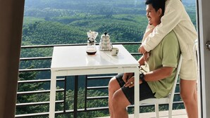 A couple seated at a table with a view of a mountain and forest. - A View Khao Soon  (Chawang)