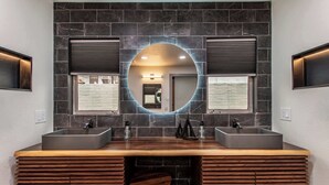A modern bathroom with two sinks, a wooden vanity, and a large mirror. - Luxury on Ocean Drive - Sleeps 28 (Corpus Christi)