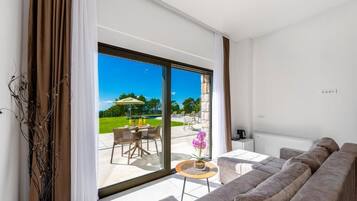 Standard Double Room, Partial Sea View | Living area | TV