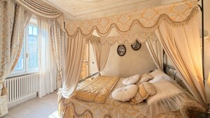 A bedroom with a canopy bed, a radiator, and a view of the outside. - Charming Tuscan Home - Near Pisa, Volterra & Wine Tours (Capannoli)