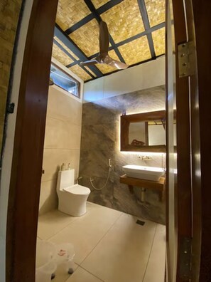 A bathroom with a toilet, sink, and shower. - Corbett Cabana Farm (Haldwani)