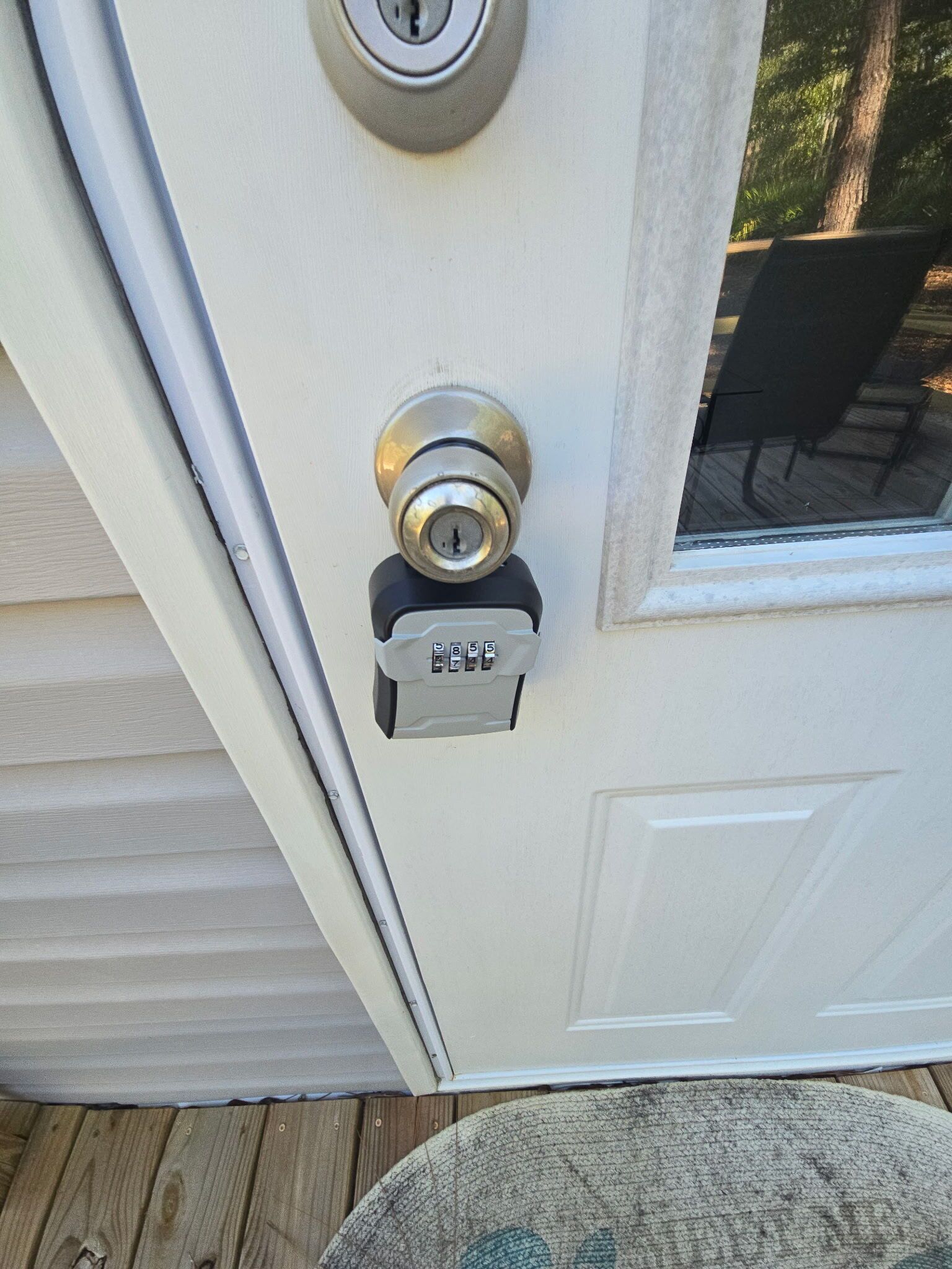 A door with a keyhole and a keypad lock.