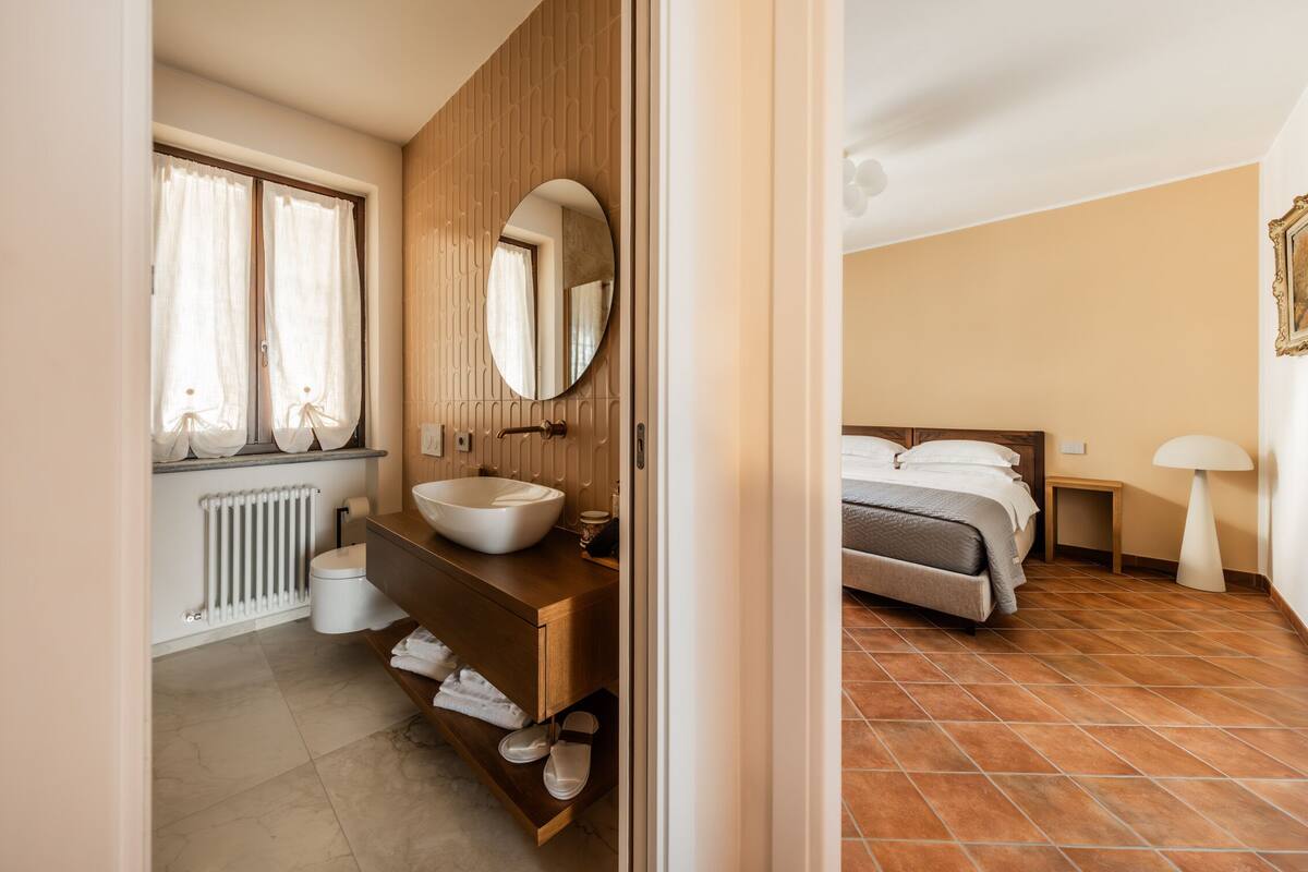 A bathroom with a sink, mirror, and towel rack.