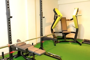A gym with weightlifting equipment, a bench, and a squat rack. - In a Residence, Air-conditioned, With Terrace (Marone)