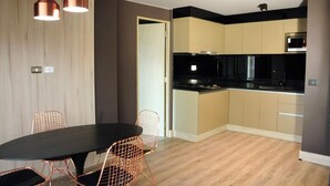 A modern kitchen with black countertops, a built-in oven, and a microwave. - Santiago Retreat EXC Modern 1 BR Apartment in Las Condes (Santiago)