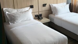 Two single beds with white linens, a bedside phone, and a wooden headboard. - Santiago Retreat Plus EXC Modern 2 BR in Las Condes (Santiago)
