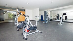 A gym with stationary bikes, a treadmill, and weight machines. - Manquehue Retreat EXC Stylish Home in Las Condes (Santiago)