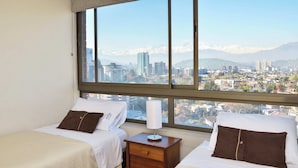 A hotel room with two beds, a nightstand, and a large window offering a cityscape view.