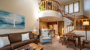 A living room with a sofa, armchair, coffee table, and a painting of a tree. - OG22 - An Eagle Ridge Resort & Spa Rental with Full Resort Amenities and Owners Club Access! (Galena)