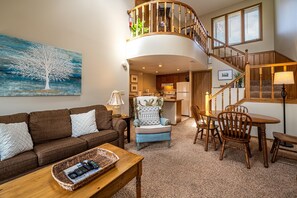 A living room with a sofa, armchair, coffee table, and a painting of a tree. - OG22 - An Eagle Ridge Resort & Spa Rental with Full Resort Amenities and Owners Club Access! (Galena)