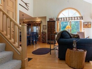 A spacious living area with a staircase, a sofa, a coffee table, and a dining area. - House 552 - An Eagle Ridge Resort & Spa Rental with Full Resort Amenities and Owners Club Access! (Galena)