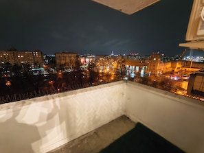 A balcony with a view of a cityscape at night, including buildings and streetlights. - Apartment F2 (living room + one bedroom) approx. 45m (București)
