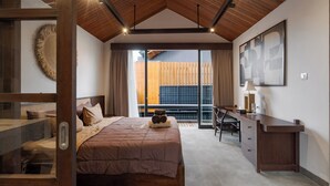 A bedroom with a bed, a desk, and a view of the outdoors. - Aluna Ubud Villas (Ubud)
