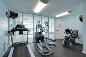 A gym with treadmills, elliptical machines, and a stationary bike. - Walk to Beach: The Dunes Condo w/ Resort Perks! (Gulf Shores)