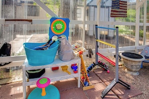 A play area with a basketball hoop, a blue bucket, a toy drum set, and a small ball pit. - Colorado Countryside Living 7 Mi to Chatfield Res! (Louviers)