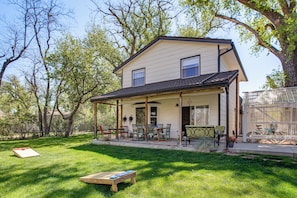 A two-story house with a covered porch, a patio with outdoor furniture, and a bicycle in the background. - Colorado Countryside Living 7 Mi to Chatfield Res! (Louviers)