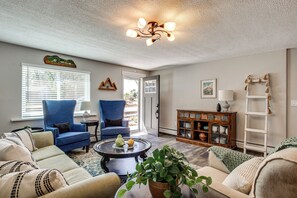 A living room with a sofa, two armchairs, a coffee table, a potted plant, a cabinet, and a ceiling fan. - Colorado Countryside Living 7 Mi to Chatfield Res! (Louviers)