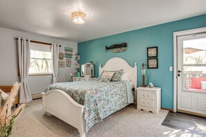 A bedroom with a bed, nightstands, a dresser, a door, and a window with curtains. - Colorado Countryside Living 7 Mi to Chatfield Res! (Louviers)