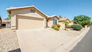 A residential house with a garage, driveway, and landscaping. - Patio & Grill! Resort-style Sun Lakes Escape (Chandler)