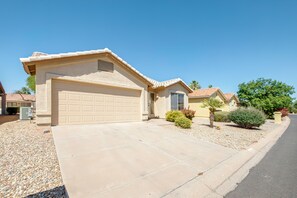 A residential house with a garage, driveway, and landscaping. - Patio & Grill! Resort-style Sun Lakes Escape (Chandler)