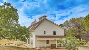 A two-story house with a porch, a chimney, and a small deck. - Hiking, Wineries & More! Mtn-view Gem in Tehachapi (Tehachapi)