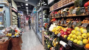 A grocery store aisle with various fruits and vegetables on display. - Captivating Loft in Prime Location Near Colosseum (Rome)