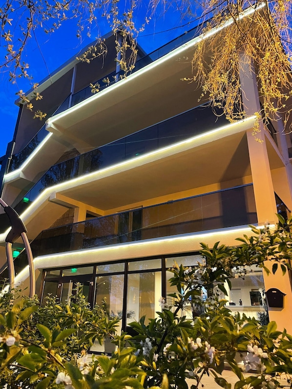 A multi-story building with balconies, large windows, and a modern architectural design.