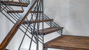 A staircase with wooden steps and metal railings.