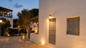 Un bâtiment à l’extérieur blanc, doté d’une porte et d’une fenêtre.