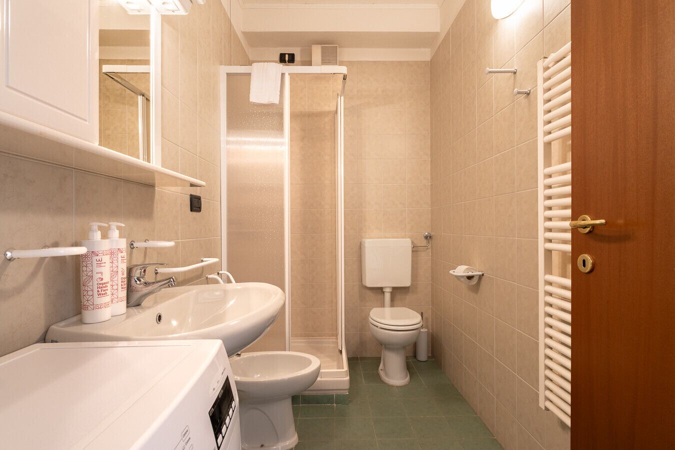 A bathroom with a sink, toilet, and shower.