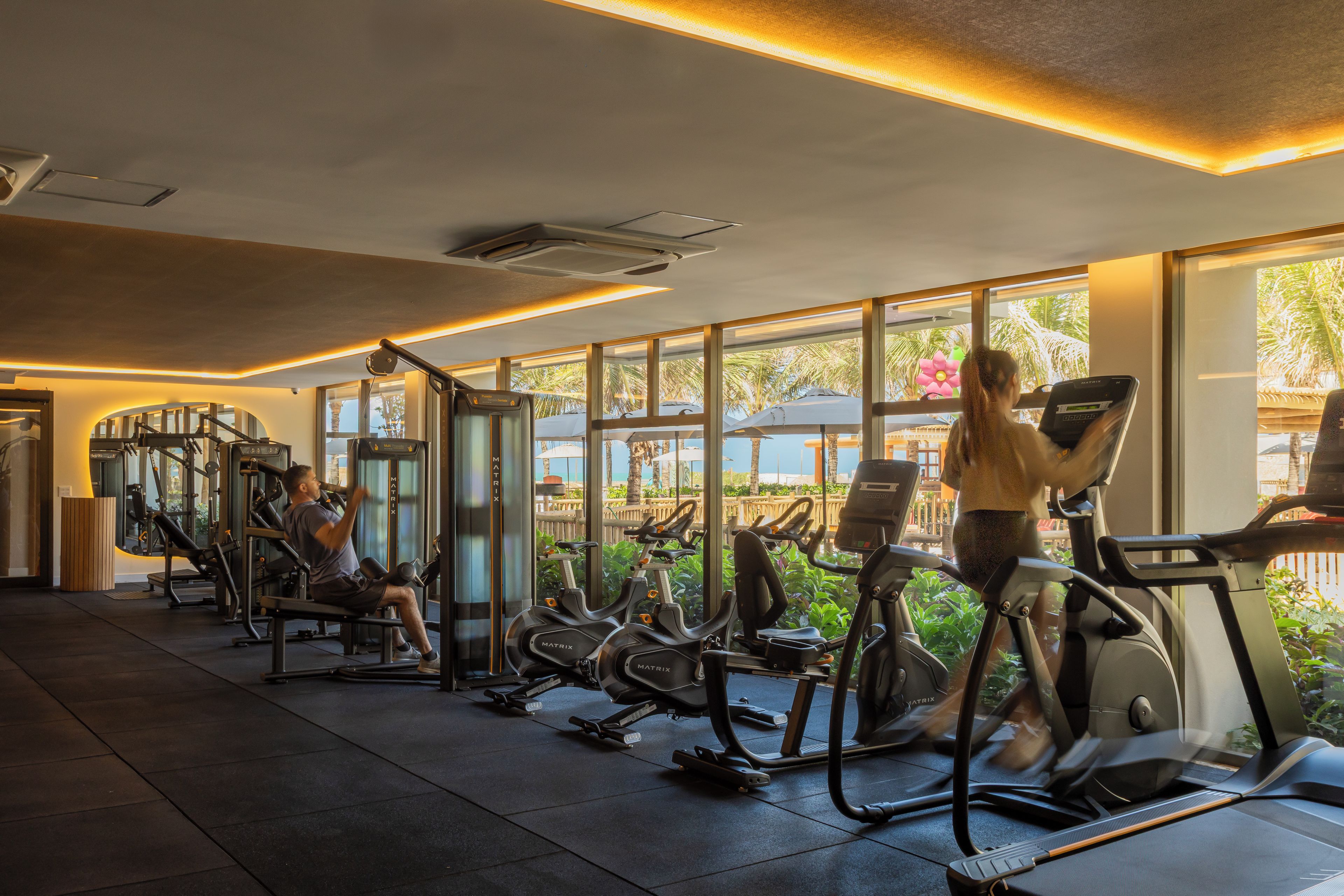 A gym with treadmills, stationary bikes, and weight machines.