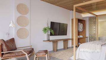 Un dormitorio moderno con techo de madera, una cama, un escritorio con televisor, una silla y una planta.