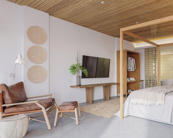 A modern bedroom with a wooden ceiling, a bed, a desk with a TV, a chair, and a plant.
