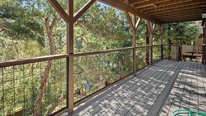 A wooden deck with a metal railing overlooking a forested area. - New Listing--A Woodland Escape--Call for Monthly Rates (Cambria)