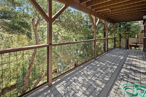 A wooden deck with a metal railing overlooking a forested area. - New Listing--A Woodland Escape--Call for Monthly Rates (Cambria)