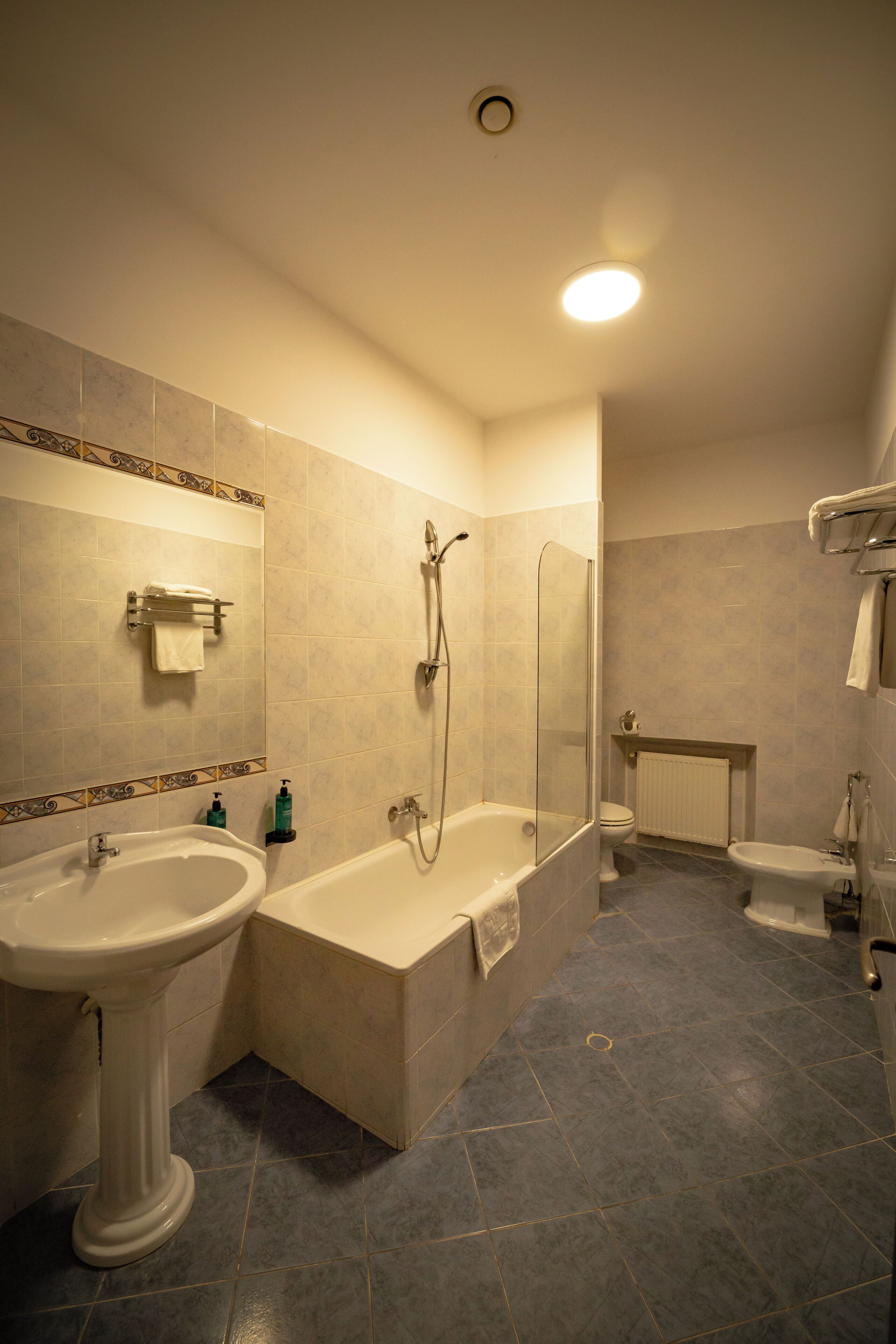 A bathroom with a bathtub, a sink, a toilet, and a shower.