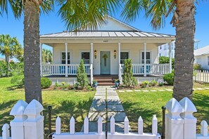 A two-story house with a front porch, a number '4463' above the door, and a pathway leading to the entrance. - 🏖️Walk to Beach | Great Location | Lule Cottage🏖️ (Destin)