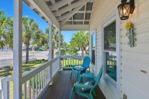 A porch with two chairs, a welcome sign, and a lantern. - 🏖️Walk to Beach | Great Location | Lule Cottage🏖️ (Destin)