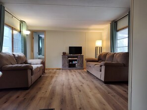Living area - 2-bedroom mobile home w/ AC at Elkwood Campground in Wolverine, MI with POOL! (Wolverine)