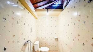 Un baño pequeño con inodoro, ducha y paredes con diseño.