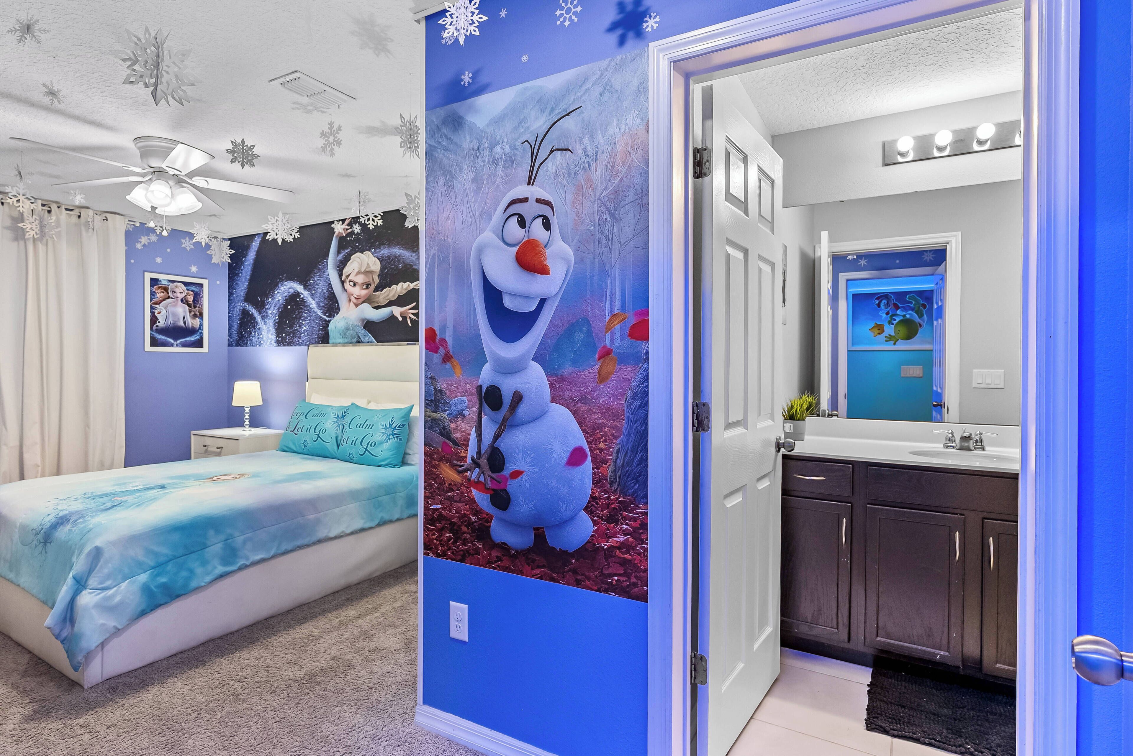 Experience a playful bedroom with vibrant blue walls and charming décor that invites relaxation. Enjoy the plush bedding and delightful mural, perfect for guests of all ages. A modern bathroom adds convenience to your stay.